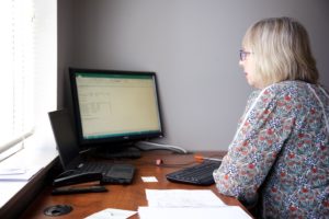 Image of engineer Rachel Dewiler at her desk looking at her computer.