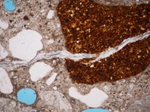 optical microscope image of alkali-silica-reactive aggregate in concrete