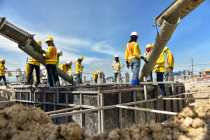 Placement of concrete in forms with shoring.