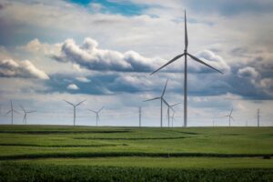 wind turbines in cornfield in Iowa with storm clouds in background