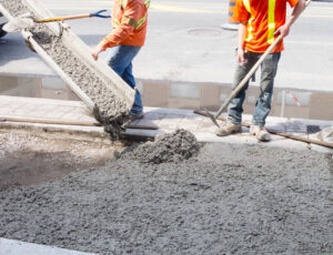 Concrete being deposited from chute onto slab