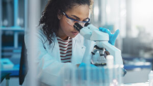 young black woman at microscope